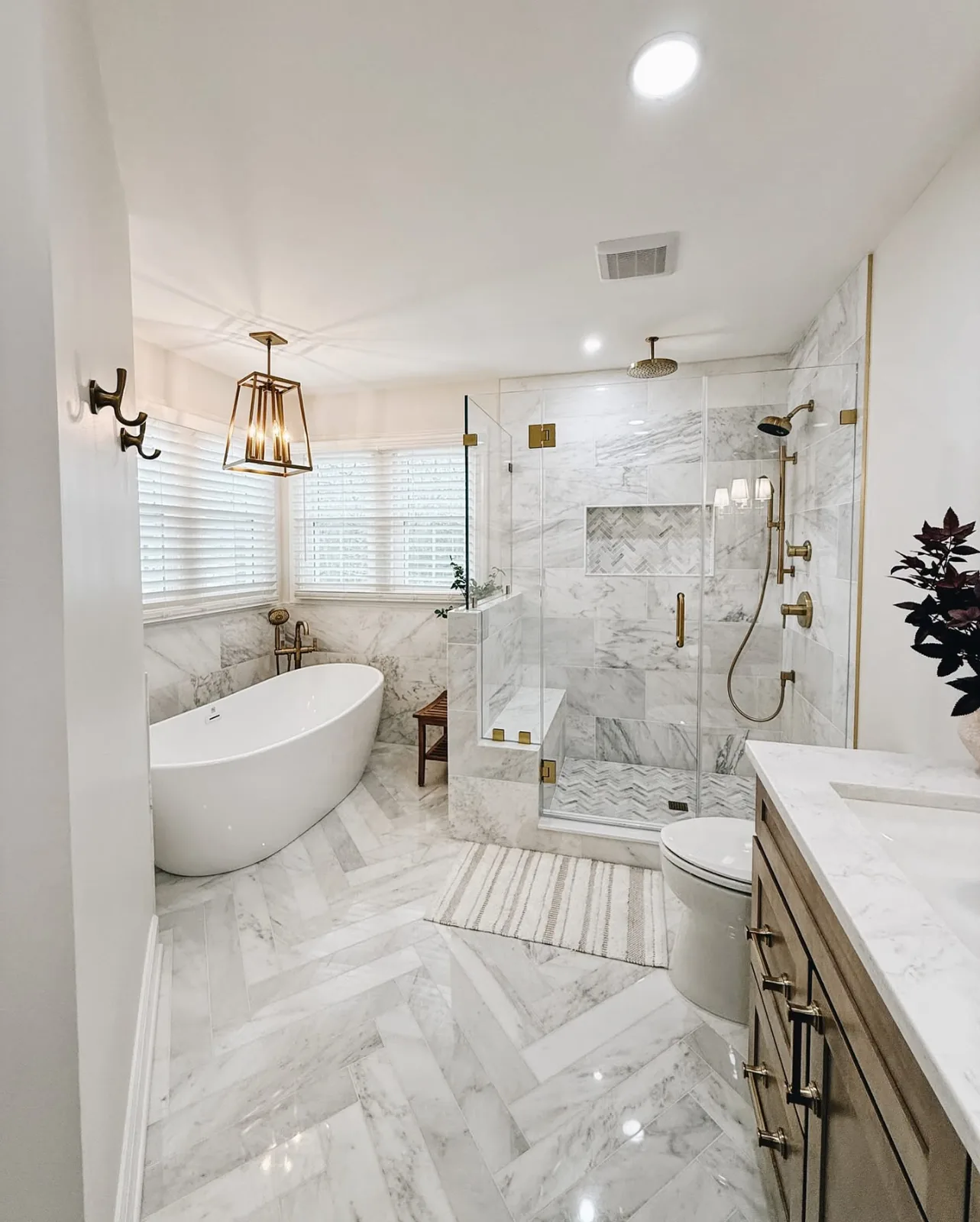 Walk-in shower with marble tile and glass enclosure